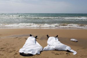 Bodies of migrants who drowned lie on the beach in the Sicilian village of Sampieri