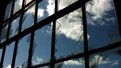 stock-footage-broken-factory-window-timelapse-clouds